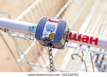 SAMARA, RUSSIA - MARCH 14, 2015: Empty red shopping cart Auchan store. French distribution network Auchan unites more than 1300 shops