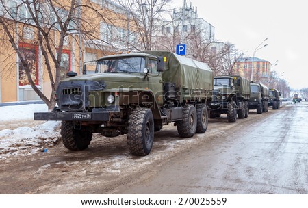 SAMARA, RUSSIA - FEBRUARY 22, 2015: Green russian military truck URAL 4320 worth in the row on a city street