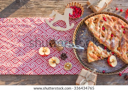 Christmas cake on a wooden background, tablecloth, berries and Christmas decor