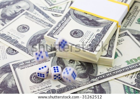 In the shot a model of denominations. It\'s not real money. Max focus on two bottom dices and a denomination under them