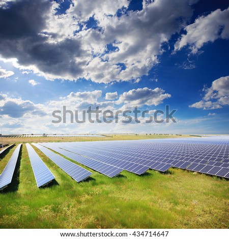 Solar panels with green field