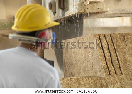 machine cutting a granite block