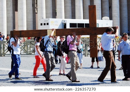 ROME, ITALY - MAY 30: Vatican city center life - pilgrims carry cross on May 30, 2014, Rome, Italy.