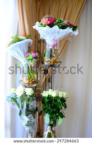 Close up of natural wedding flowers in the vases.