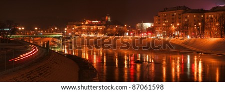 Vilnius city lights reflection in the river Neris.