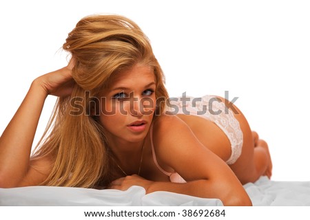 stock photo Cute young blond girl laying on a bed in panties isolated