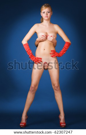 stock photo Cute young blond girl naked with red gloves blue background