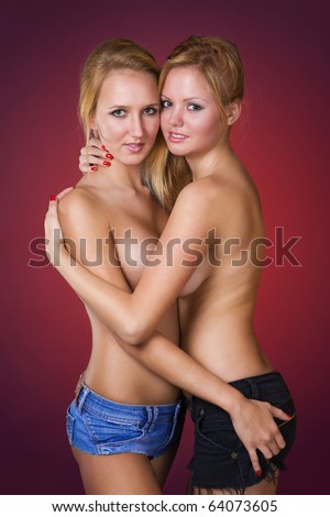 stock photo Attractive young blond girls in denim shorts topless red