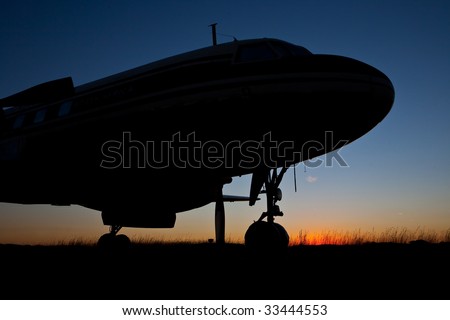 Aircraft Silhouette against setting sun skyline