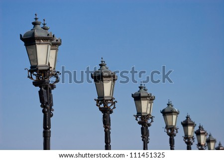 A Row of antique lanterns standing on the Patriarshiy Bridge. Moscow, Russia