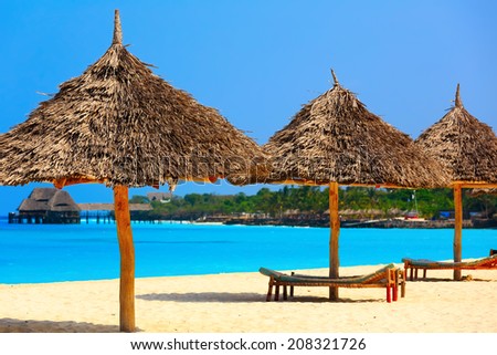 Umbrella and lounges at the shore of Indian Ocean, Kendwa beach, Zanzibar, Tanzania