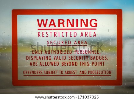 A Red Airport Security Restricted Area Warning Sign