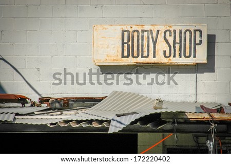 Recession Image Of Grungy Sign For A Rundown Body Shop