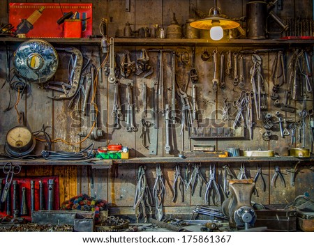 Vintage Tools Hanging On A Wall In A Tool Shed Or Workshop
