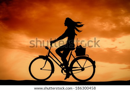 Retro Styled Photo Of A Girl On A Bike At Sunset