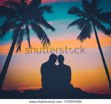 Retro FIltered Image Of A Romantic Couple At Sunset In Hawaii With Palm Trees