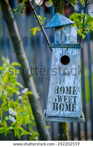 Retro Filtered Rustic Bird House With Home Sweet Home Printed On Peeling Paint