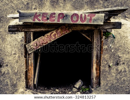 Conceptual Image Of A An Entrance To An Old Mine Tunnel With Keep Out And Danger Signs