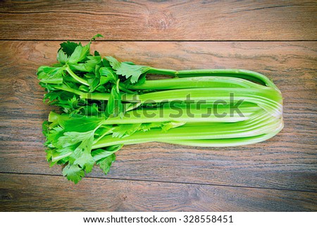 Fresh Juicy Celery on Woody Background. Studio Photo.