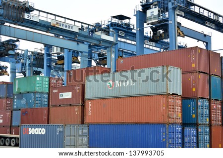 XIAMEN - APRIL 21: Container goods yard and operation in Xiamen, Fujian, South of China in April 21, 2013. Xiamen is a developing harbor city located in South-East of China.