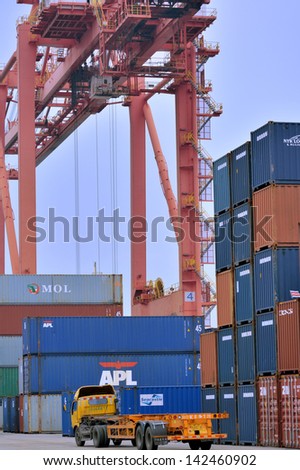 XIAMEN - APRIL 21: Container yard and equipment in Xiamen, Fujian, South of China in April 21, 2013. Xiamen is a developing harbor city located in South-East of China.