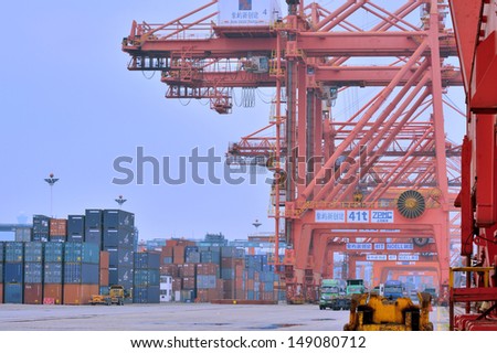 XIAMEN - APRIL 21: Container goods yard and equipment in Xiamen, Fujian, South of China in April 21, 2013. Xiamen is a developing harbor city located in South-East of China.