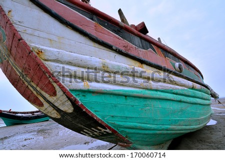 XIAMEN, CHINA- SEPTEMBER 29: Wooden fishing boat with traditional drawing in country of Xiamen, South of China in September 29, 2013. Xiamen is a famous harbor city located in South-east of China.