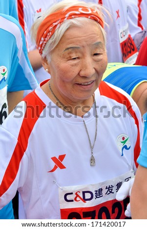 XIAMEN, CHINA- JANUARY 2: Old runner with energetic status in International marathon in Xiamen, China, January 2, 2014. Xiamen is a famous harbor city located in South-east of China.