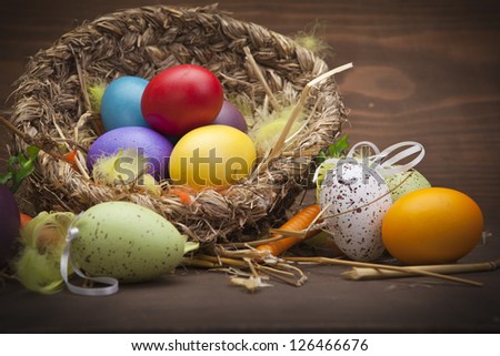Colorful easter eggs in basket. Focus is on the eggs in basket