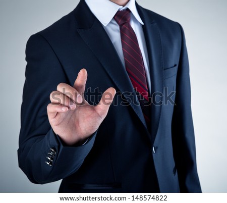 Business Man pushing on a touch screen interface