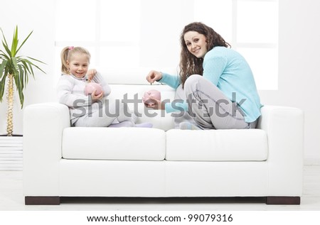Mother and Daughter on sofa learn about savings