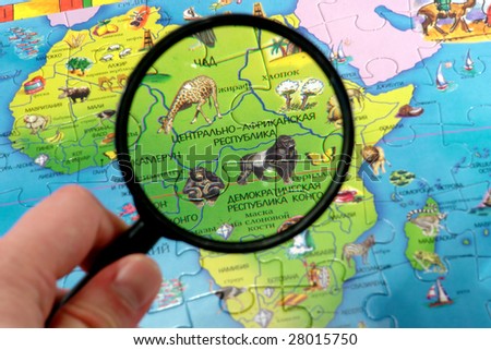 Map, magnifier and man\'s hand