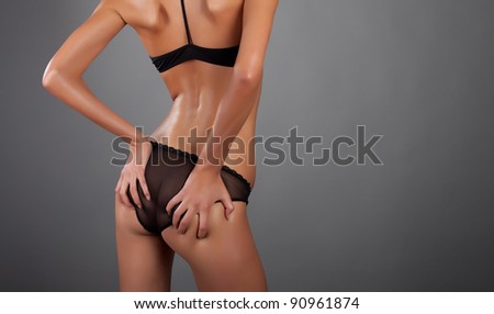 woman back and ass on a gray bg