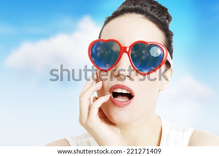 Portrait of a beautiful woman with heart shaped glasses, on white background