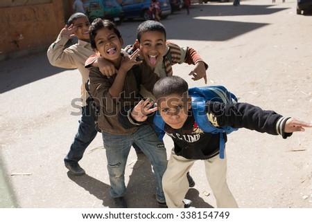 Luxor, Egypt - November 27, 2014: Local Arab pupils during the school break, playing in the street. Good mood, fun of the children
