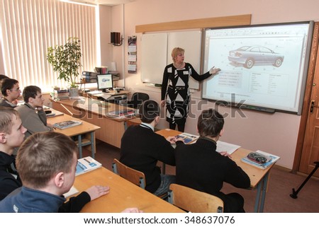 Saint-Petersburg, Russia - February 16, 2015: Students gain knowledge and skills to repair cars at the vocational college in Saint-Petersburg. Teacher with students in the classroom