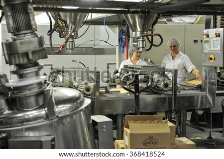 St. Petersburg, Russia - December 14, 2015: Workers on the production line for the production of wafer cakes. Plant for the production of confectionery products.