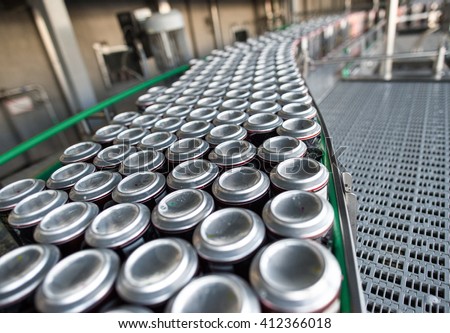 Stain-roof jars with drinks on the assembly line. for the production of alcoholic and soft drinks line. The final stage in the manufacture of the product.