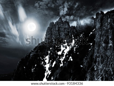 moonlit night and clouds on night sky in the mountains