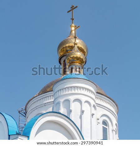 Russian church close view to the roofings with a blue sky