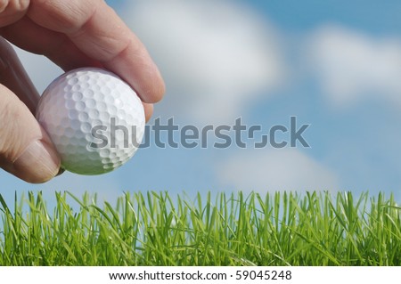 Golf ball, lawn, hand, sky,