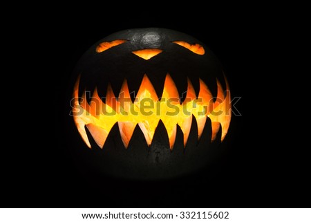 Spooky pumpkin in dark, isolated on black background