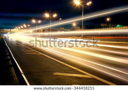night wide highway with moving cars