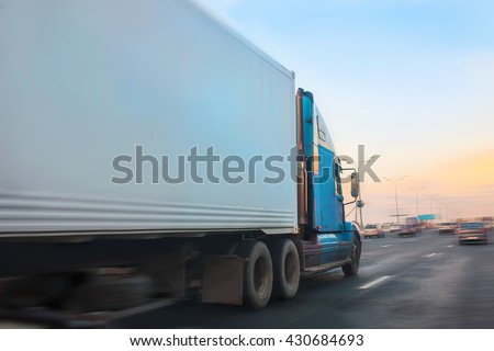 big truck moves on highway at sunrise