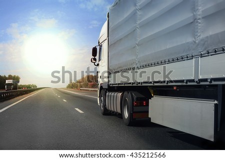 big truck goes on the highway to sunrise