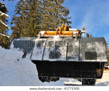 snow machine with excavator ready to work and clean the slope