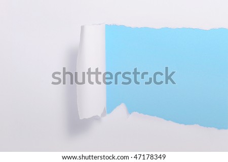 White torn paper over blue background