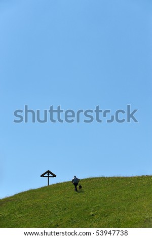 dog and man wandering in the alps