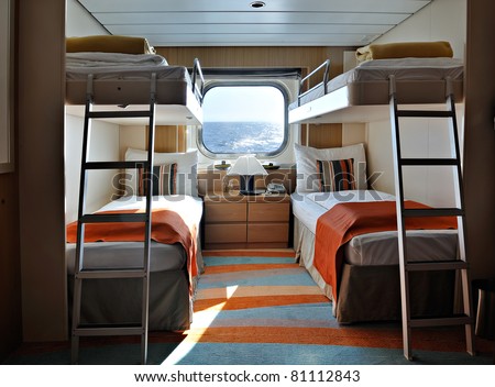 interior of a living cabin on a cruise ship - with bunk beds and window