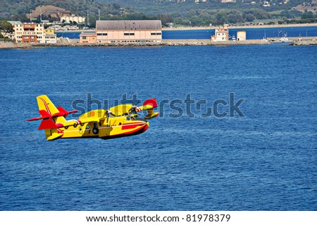rescue aircraft landing on the sea to put water in. operation to extinguish a forest fire.
